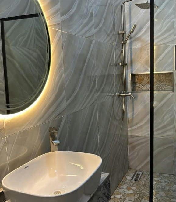 Bathroom with illuminated mirror and rain shower