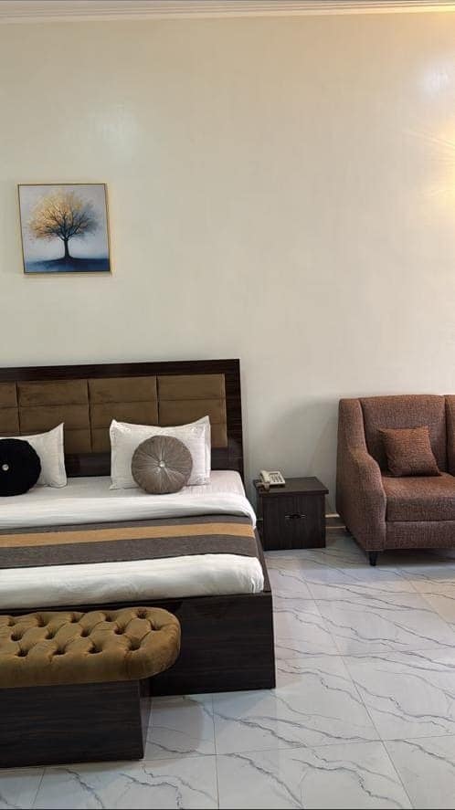 Executive room bed and bedside table with telephone