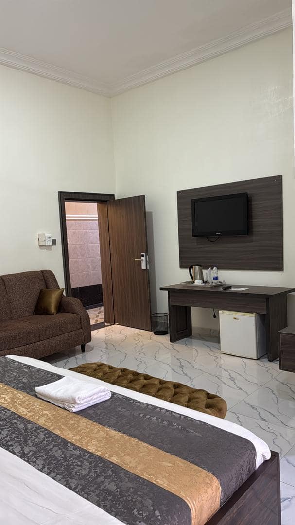 Executive room with television, tea station and mini fridge