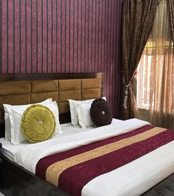 Bedroom with burgundy and gold bedding
