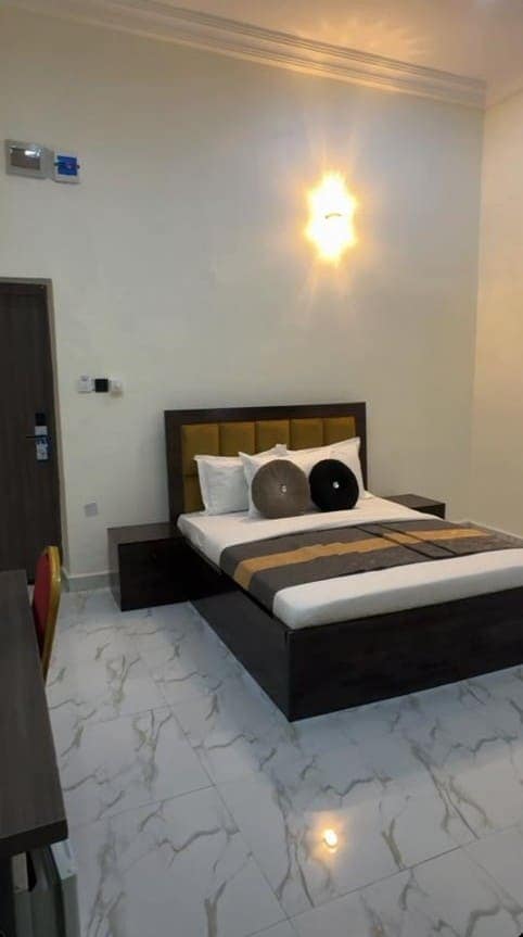 Standard room with double bed and wall light