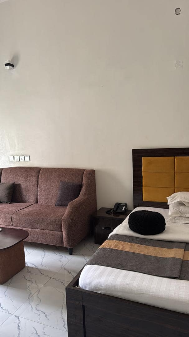 Superior room with bed, sofa and bedside table